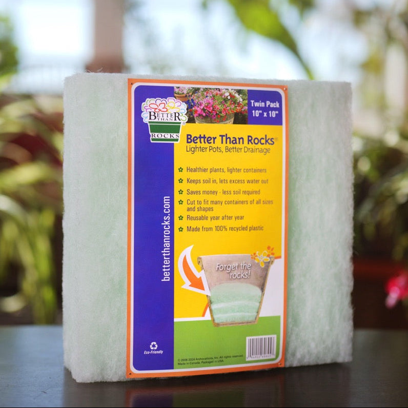 Better Than Rocks 10&quot; × 10&quot; inch planter drainage insert on a tabletop, ideal for improving drainage in 10 inch plant pots, with indoor plants in the background.