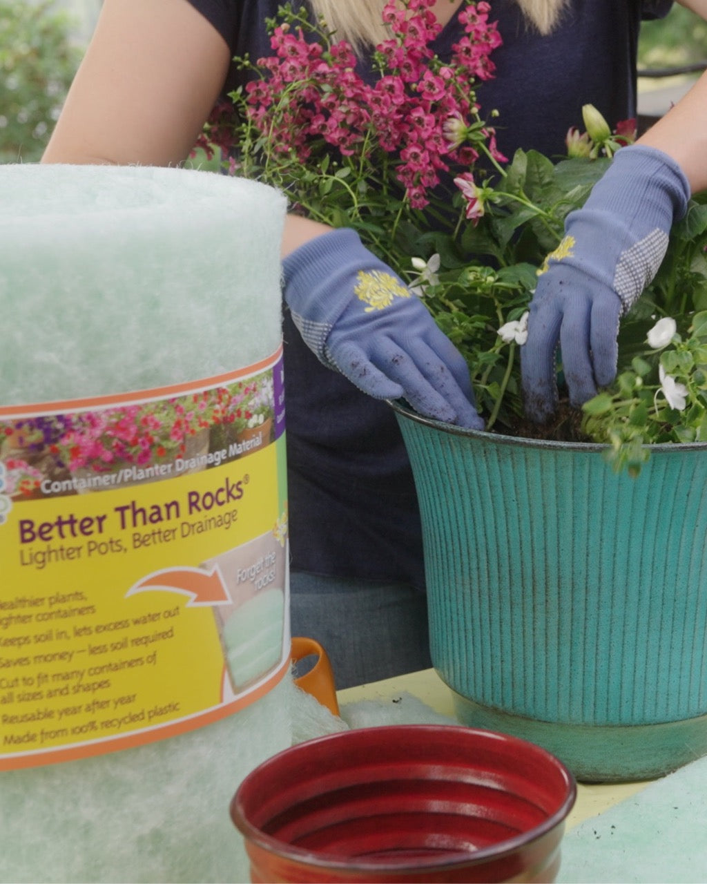 Gardener preparing to plant using Better Than Rocks planter drainage material in a large container.